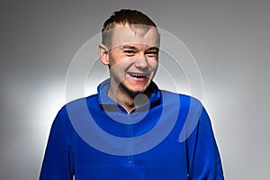 Photo of smiling man in blue pullover