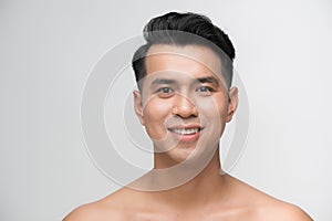 Photo of smiling mature man standing isolated over white wall background naked. Looking camera