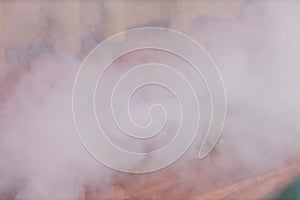 Photo of smoke created with an electric fog machine on an empty stage. Smoke machine on a stage