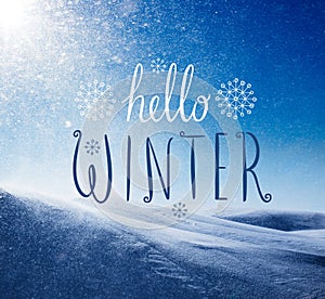 Photo of snowstorm in sunny day with Hello Winter lettering.