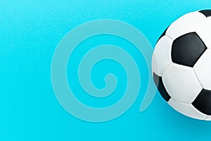 Photo of soccer ball over turquoise blue background with copy space