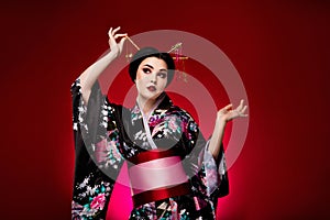 Photo of sophisticated lady dressed black japanese traditional ceremony empty space isolated on red color background