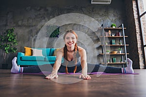 Photo of sportive girl trainer have online training doing stretching exercise in house gym