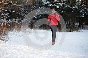 Photo of sports girl on morning run in winter park