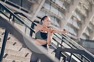 Photo of sporty dynamic challenge lady stretch arm prepare marathon competition town center outside gym