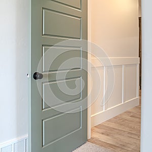 Photo Square frame House interior with transom window above the gray door with black door knob