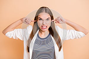 Photo of stressed irritated girl fingers close ears wear white jacket isolated pastel beige color background