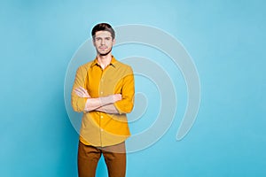 Photo of strict serious man with arms crossed looking at you intently near empty space isolated over blue pastel color