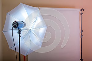 Photo Studio, flash light with white umbrella and white paper background