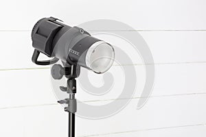 Photo studio flash projector on wood background