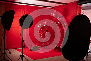 Photo studio interior with group of red heart shaped balloons photo
