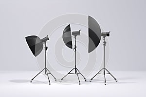 Photo studio lighting stands with flash  umbrella and softbox on the white