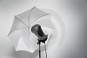 Photo studio lightning - strobe flash with white umbrella
