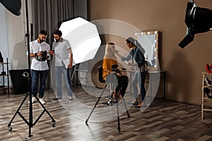 Photo studio with professional equipment and workers