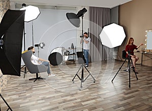 Photo studio with professional equipment and workers