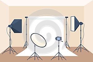 Photo studio with white blank background, soft box light, camera, spotlight. Professional equipment for photo and video shooting.