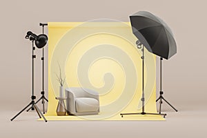 Photo studio with yellow cyclorama and armchair, soft box on tripod