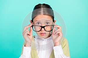 Photo of stunned lady take off specs unfair mark reaction wear green top cardigan isolated turquoise color background