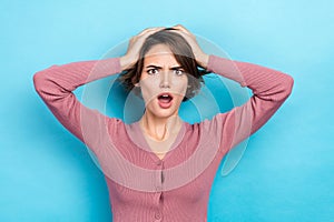 Photo of stunned shocked lady hold arms on head stupor bad news epic fail wear pink shirt isolated blue color background
