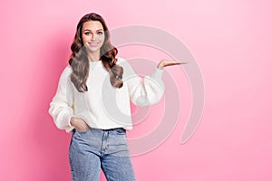 Photo of stunning sweet girl toothy smile arm palm hold empty space isolated on pink color background