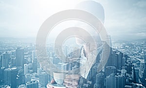 Photo of stylish adult businessman wearing trendy suit and holding cup coffee. Double exposure, panoramic view contemporary city.