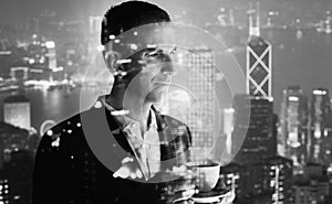 Photo of stylish adult businessman wearing trendy suit and holding cup coffee. Double exposure, panoramic view contemporary city s