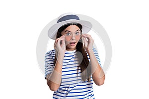 photo of summer style shocked teen girl wearing hat and sunglasses. summer style teen girl