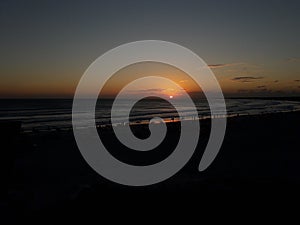 Photo of Summer sunset in Arraial do Cabo - late afternoon with people on the beach sand