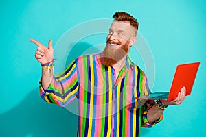 Photo of support client service manager redhair man pointing finger empty space with laptop telegram bot isolated on