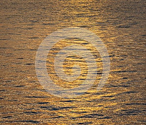 Photo of the surface water in the sunset time. Calm sea, meditation ocean background. Tranquil seascape