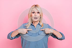 Photo of surprised excited stressed old business woman blonde hair direct fingers herself shocked stupor isolated on