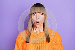 Photo of surprised woman open mouth look camera wear orange sweater isolated purple color background