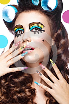 Photo of surprised young woman with professional comic pop art make-up and design manicure. Creative beauty style.