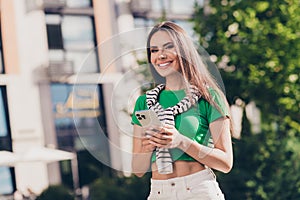 Photo of sweet adorable lady wear green t-shirt texting instagram twitter telegram facebook outside urban city street