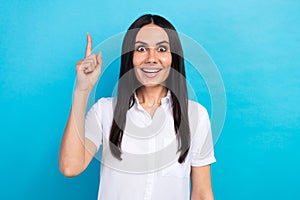 Photo of sweet excited girl dressed white shirt pointing finger having great idea isolated blue color background