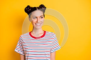 Photo of sweet funny young woman wear striped t-shirt lokking empty space isolated yellow color background