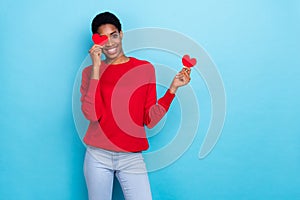 Photo of sweet millennial lady hold hearts wear red shirt isolated on blue color background