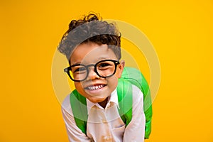 Photo of sweet positive schoolboy beaming smile good mood carry backpack isolated on yellow color background