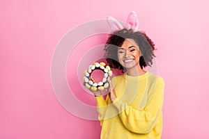 Photo of sweet pretty woman dressed kitted pullover easter headband holding wreath empty space isolated pink color