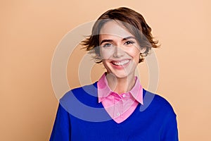 Photo of sweet shiny lady dressed blue sweater smiling empty space isolated beige color background