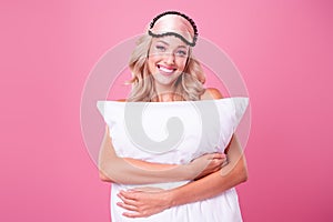 Photo of sweet shiny lady dressed silk nightwear mask cuddling soft pillow isolated pink color background