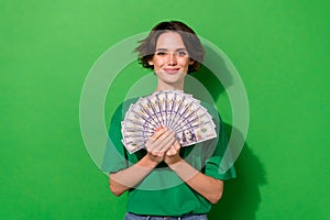 Photo of sweet shiny lady wear spring outfit holding money fan smiling isolated green color background