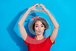 Photo of sweet young brunette lady hold show heart wear red t-shirt band isolated on blue color background