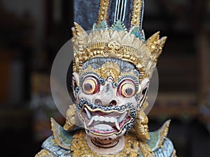 A close-up of a painted statuette of Garuda the half-man half-bird in Bali, Indonesia photo
