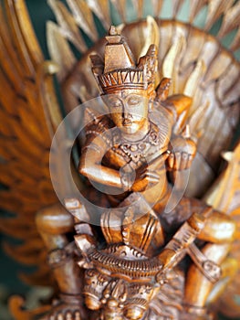 A close-up of a painted statuette of Garuda the half-man half-bird in Bali, Indonesia photo
