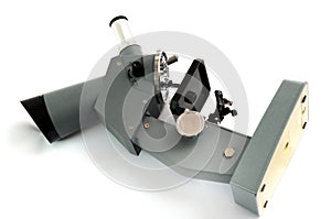 A laboratory multiple high magnification microscope toy replica against a white backdrop