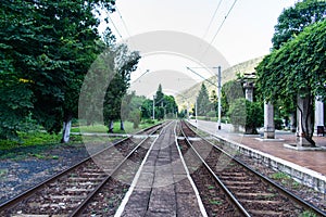 Photo taken in an old train station. Parallel railways