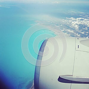 photo taken through a plane window over ocean