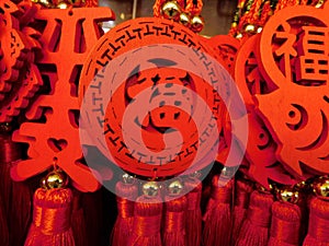 Several bright vivid red Lunar Chinese new year ornaments on display