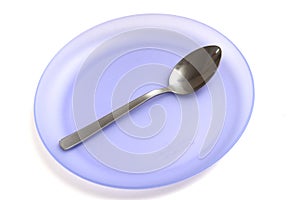 A single purple plastic plate with a single metal spoon